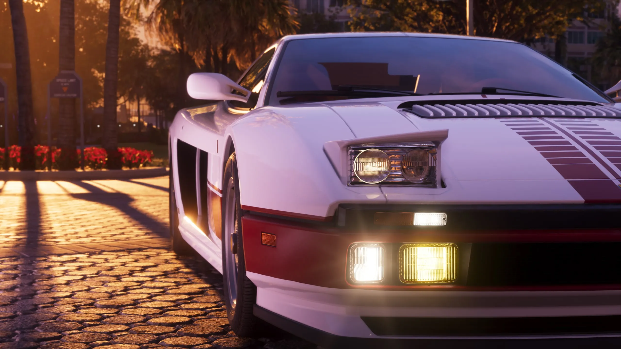 A white 1995 Grotti Cheetah at sunset with its lights on