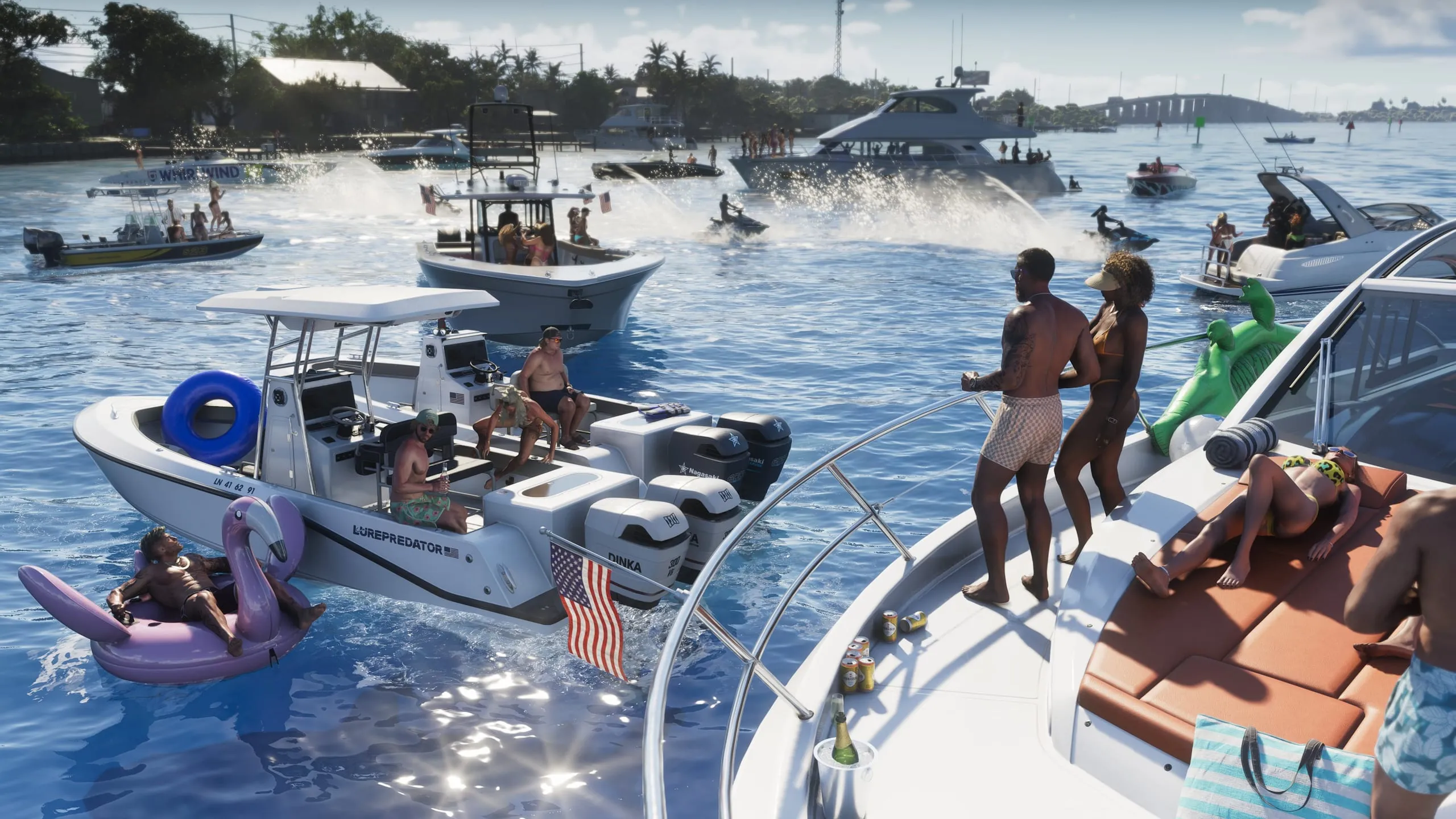 A sandbar boat party: speedboats, jet skis and an inflatable flamingo
