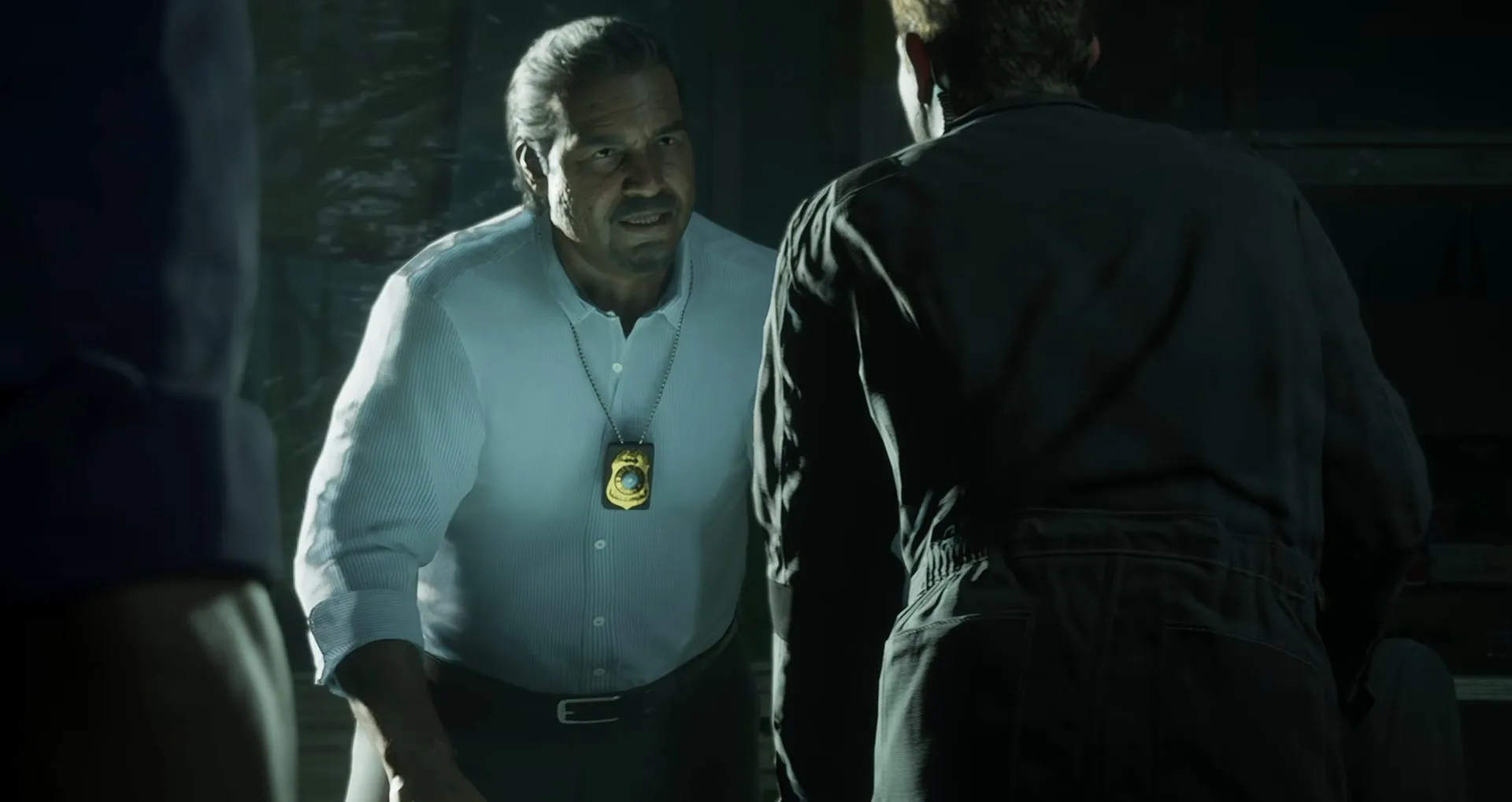 An older detective with a gold shield on a chain talking to Jason
