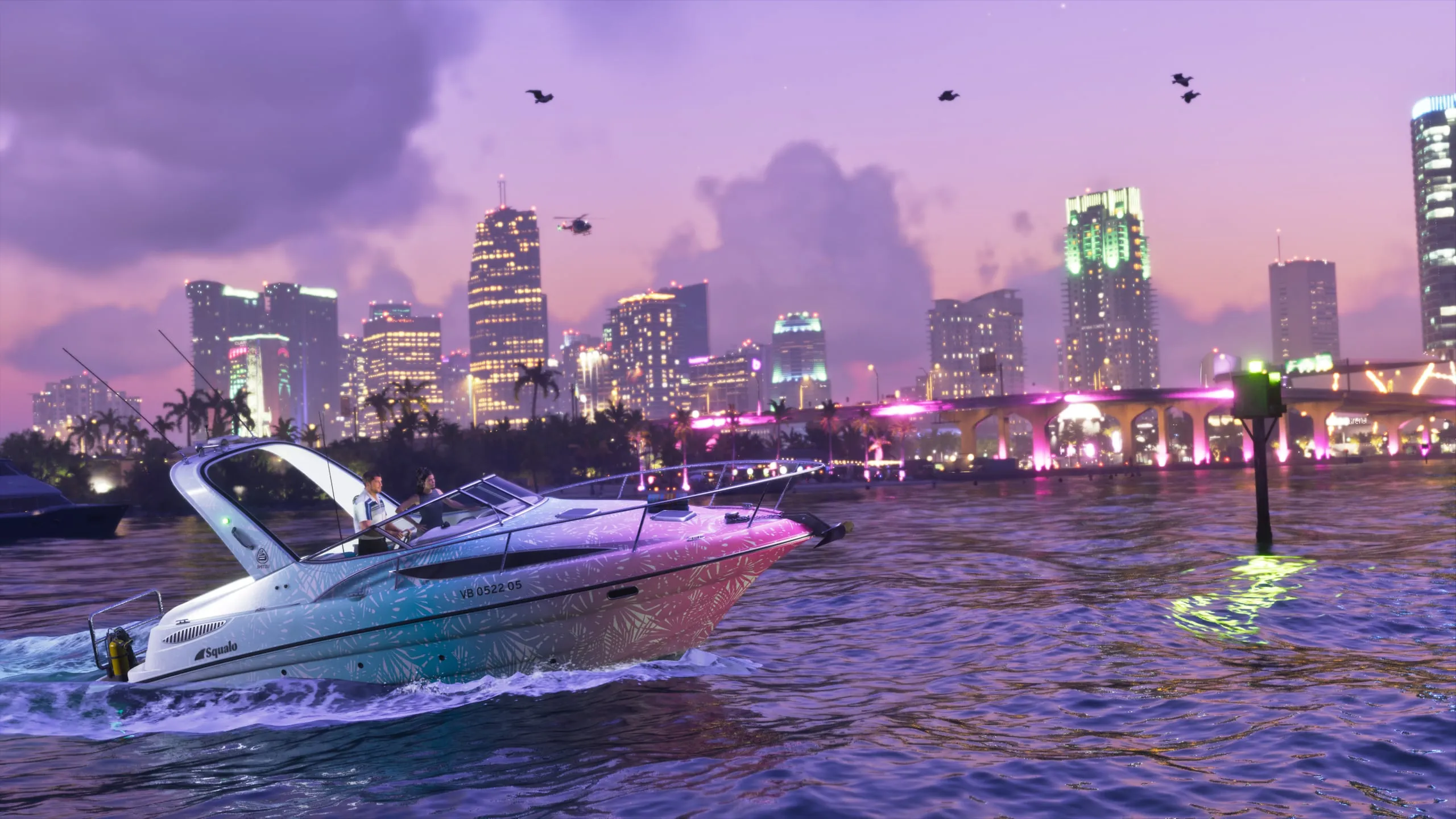 The pink-and-white Shitzu Squalo boat against the night downtown